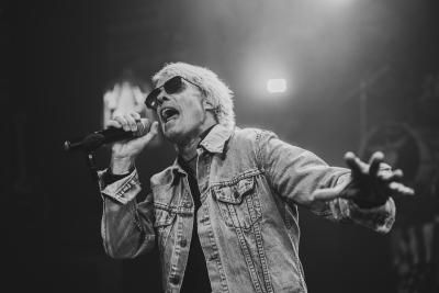 Black and white image of a singer performing with The Bon Jovi Experience